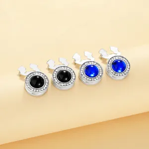 Macro view of four elegant round cufflinks featuring blue and black stones with rhinestones