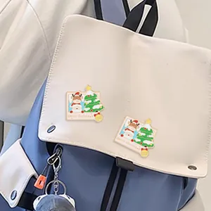 Cute Christmas enamel pin set featuring reindeer and trees on a blue backpack
