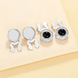 Detailed view of silver cufflink fasteners with black spheres and rhinestone borders
