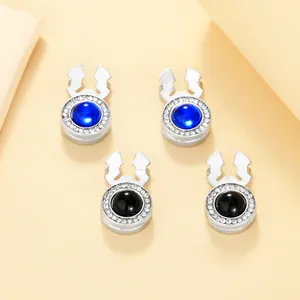 Detail of luxury rhinestone cufflinks with black and blue gemstone inlays in silver setting