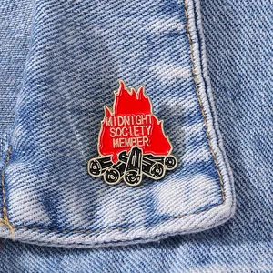 Ghost Bonfire Midnight Society Member enamel pin on blue denim jacket fabric