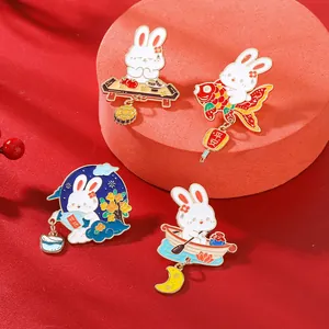 Detail of four rabbit enamel pins with traditional Chinese Mid-Autumn festival motifs