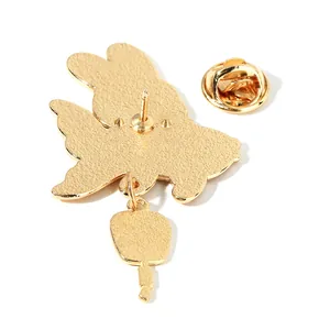 Golden metal rabbit pin back view with textured surface and secure butterfly clasp