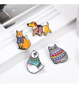 Detailed close-up of winter-themed animal enamel pins on a white decorative display stand