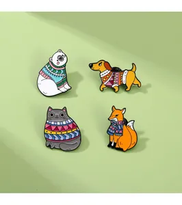 Detailed view of four cute animal enamel pins featuring fox and bear in winter sweaters