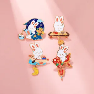 Detailed macro of four enamel bunny pins with traditional Chinese festive motifs
