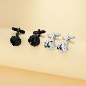 Detail shot of silver and black metal wire woven knot cufflinks for men's shirts