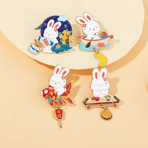 Detailed set of four cartoon rabbit enamel pins with gold plating and festive motifs