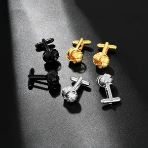Detailed macro view of woven knot cufflinks in polished black gold and silver metal finishes