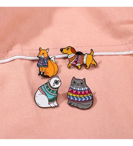 Detail view of four cute cartoon animal enamel pins with colorful patterned sweaters