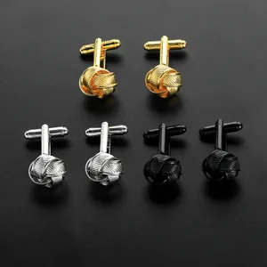 Detailed close-up of woven knot cufflinks in gold, silver, and black metallic finish