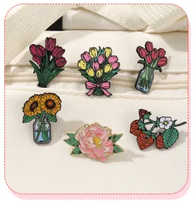 Detail of tulip and peony enamel pins pinned on a beige textured canvas bag