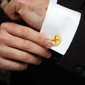 Polished gold knot cufflinks for men's French shirt cuffs shown on a black suit