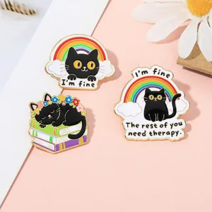 Detailed view of three cute black cat enamel pins with rainbow and funny quotes on cards