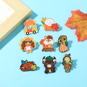 Collection of Thanksgiving enamel pins featuring turkeys and pumpkins on a blue background