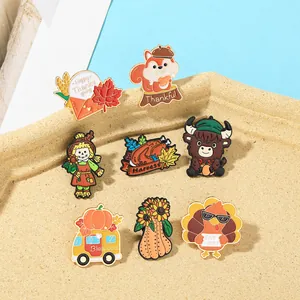 Flat lay of eight Thanksgiving enamel pins including turkeys and pumpkins on a tray