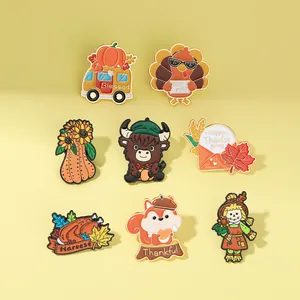 Detail view of 8 Thanksgiving enamel pins including turkeys, pumpkins and squirrels