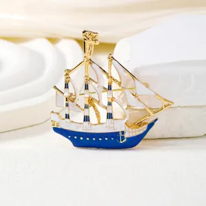 Creative nautical sailing ship brooch with white and blue enamel in gold finish