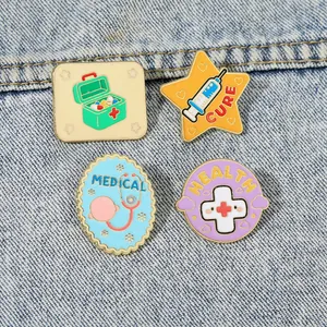 Set of four colorful medical enamel pins featuring a stethoscope and syringe on denim