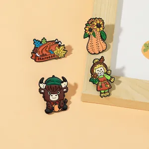 Detail view of 4 Thanksgiving enamel pins featuring turkey, pumpkin, and Harvest text
