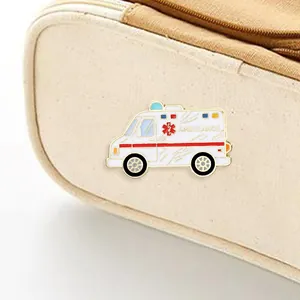 Detail of white enamel ambulance brooch with red Star of Life and medical lettering