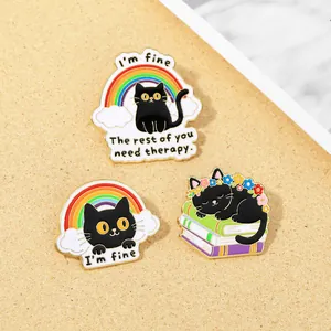 Detailed view of three cute black cat enamel pins with rainbow quotes on cork background