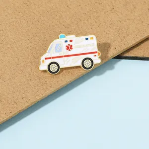 Close-up of ambulance enamel pin with Life Star symbol and gold metallic detailing