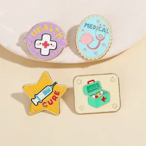 Macro shot of cartoon medical enamel pins featuring health icons on a ceramic tray