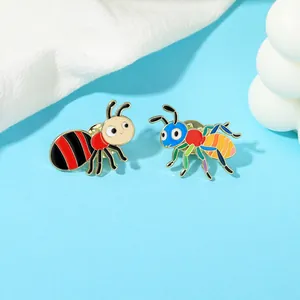 Detail of colorful ant-shaped enamel pins with high-gloss finish and butterfly clasps