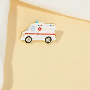 Detailed close-up of a white and gold ambulance enamel pin for medical uniforms