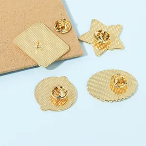 Set of four gold metal badges with butterfly pin clasps for doctors and nurses