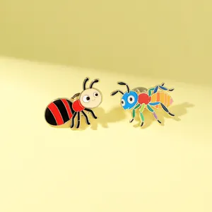 Close-up of colorful insect enamel pins featuring creative cartoon ant designs