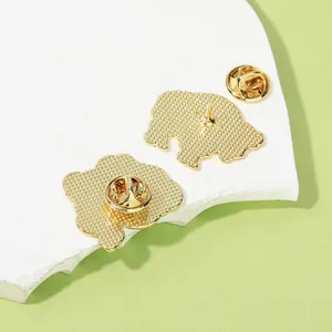 Back view of cartoon yak enamel pin with golden metal texture and butterfly clutch
