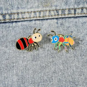 Detail of colorful cartoon ant pins with enamel finish on blue denim background