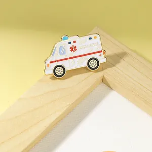 Detail of ambulance enamel pin with medical red cross and high-quality metal plating