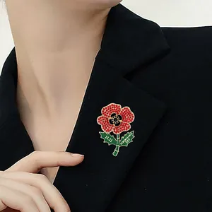 Poppy flower brooch with red rhinestones and 11.11 Remembrance Day text on black blazer