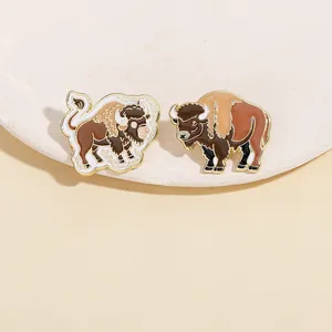 Detailed view of creative yak enamel pins with brown and black metal alloy finishes