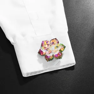 Exquisite crystal flower cufflink with iridescent petals on white shirt sleeve
