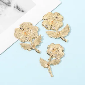 Three-piece gold crystal flower brooch set with textured leaf design and safety pin clasp