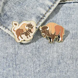 Detailed view of creative yak enamel pins pinned on blue denim fabric background
