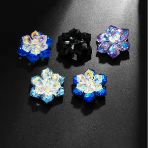 Macro detail of multi-colored crystal flower cufflinks showing faceted sparkle and texture