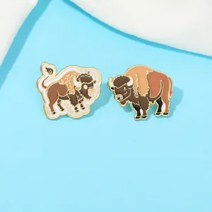 Detailed macro view of two bison enamel pins with realistic dark brown and khaki details