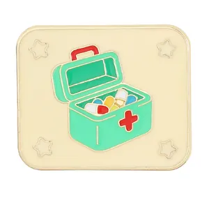 Creative first aid kit enamel pin with red cross and colorful medical capsules design