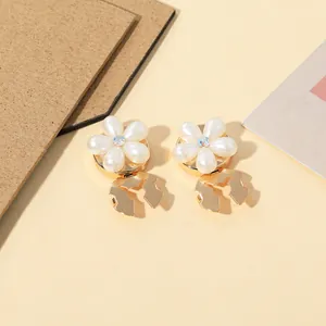 Detail of five-petal pearl flower collar clips with colorful aurora rhinestone center