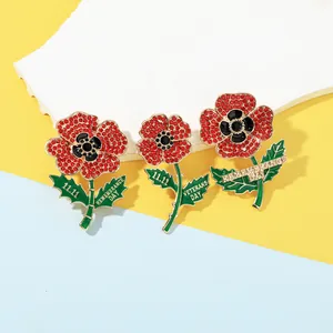 Detailed macro view of crystal poppy brooches with Veterans Day gold lettering