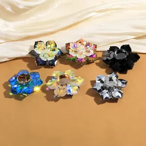 Detail of luxury crystal flower cufflinks with faceted gemstones on elegant silk fabric