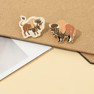 Detailed close-up of cartoon yak enamel pins crafted with textured alloy and colorful oil drops
