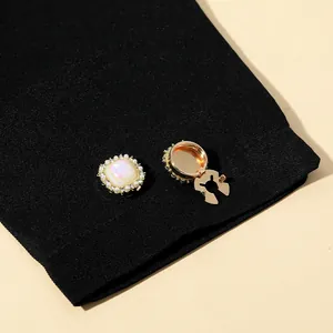 Detailed macro view of square mother-of-pearl collar buttons with small pearl border