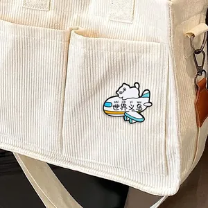 Cartoon white cat enamel pin on airplane on a corduroy bag, creative cute metal badge