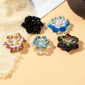 Detail showing five colors of crystal flower cufflinks with multi-faceted petals and shine